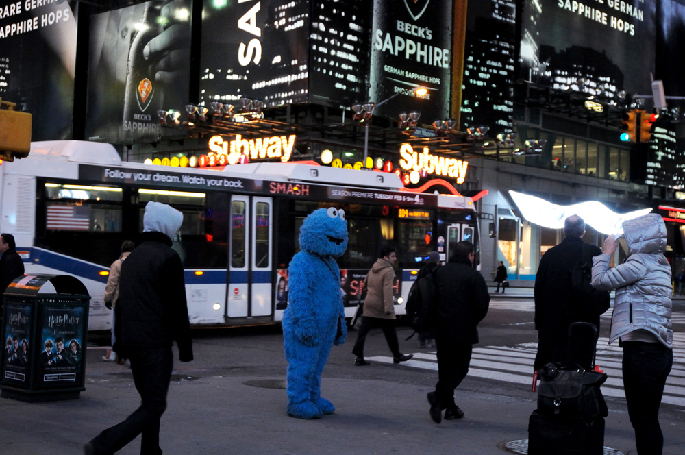 New York, United States. Immigrant dressed up as Cokie Monster ask for donations after posing for pictures in Times Square. 2013 ©Joana Toro.